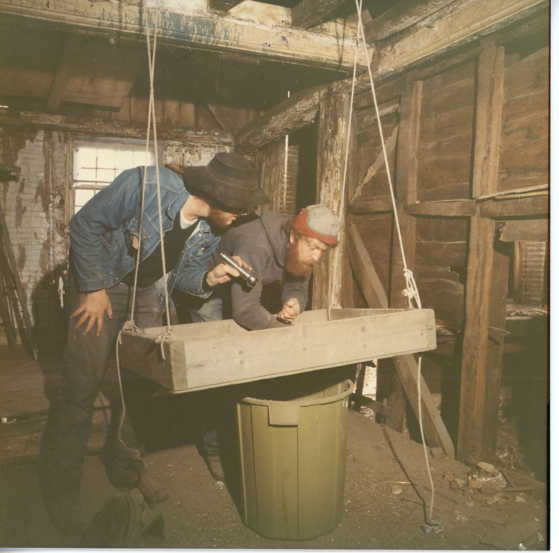 Searching for artifacts in the dirt from the ceiling that the crew had pulled down.